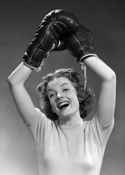 1950S Portrait Of Woman Wearing Boxing Gloves In Winning Pose Raised Overhead