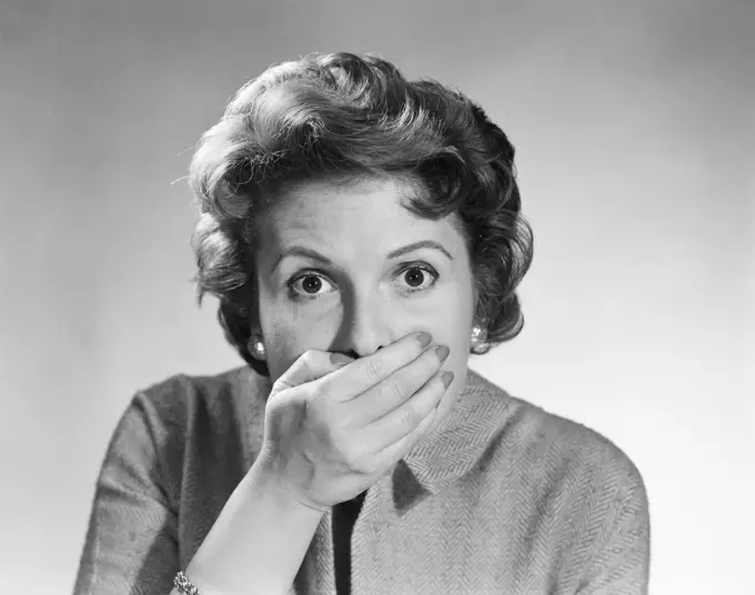 1950S Head Shot Of Startled Woman Covering Mouth With Hand 