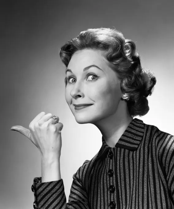 1960S Portrait Of Proud Smiling Woman Making Go Away Gesture With Thumb Studio