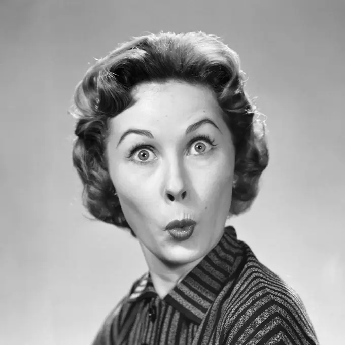 1950S Woman Making Funny Face Eyes Wide Lips Pursed As In A Kiss Or A Whistle