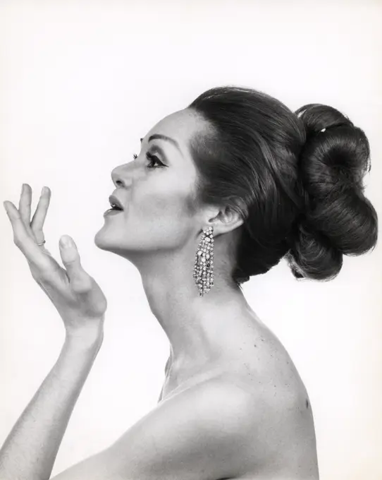 1970S Profile Portrait Of Glamorous Woman With Bare Shoulders & High Fashion Makeup And Hairstyle