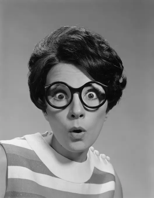 1960S Portrait Brunette Wearing Dark Thick Round Eyeglasses With Eyes Wide Open