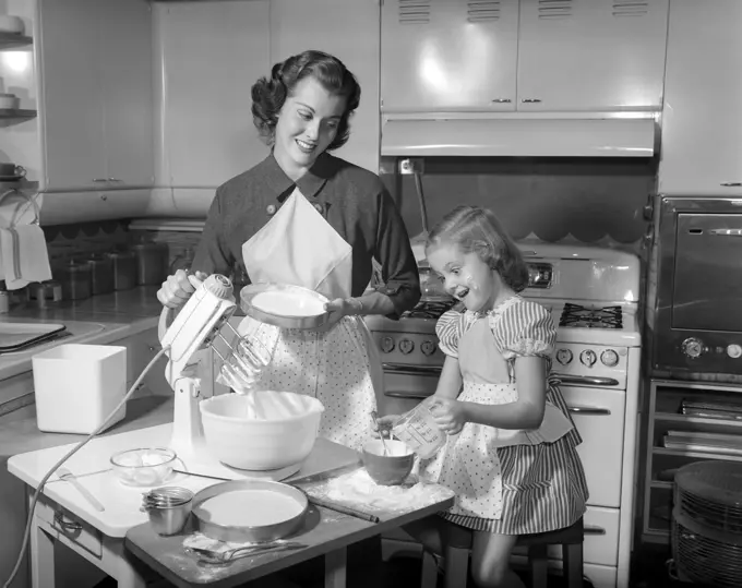 1950S Mother & Daughter Baking A Cake