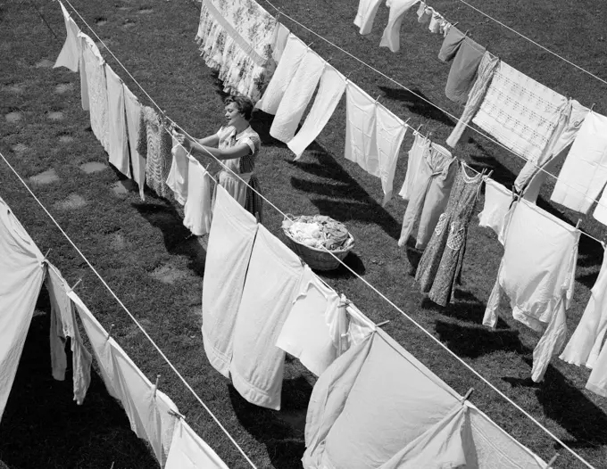 1950S Housewife Hanging Laundry In Backyard