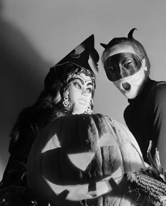 1950S Two Children In Halloween Costume Behind A Carved Pumpkin Jack-O-Lantern