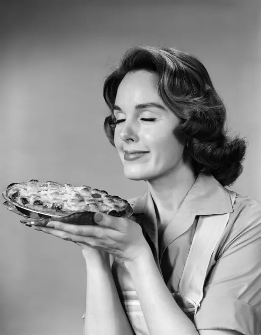 1950S 1960S Woman Smelling Aroma Of Freshly Baked Pie  