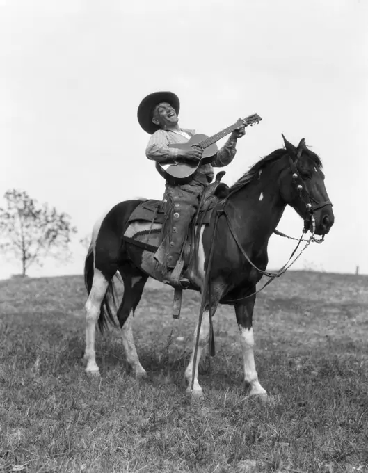 1920S Cowboy On Horse Singing & Playing Guitar