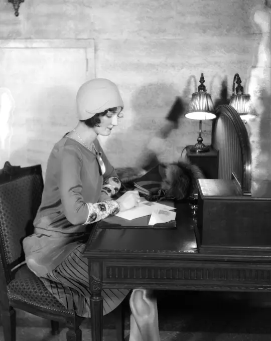 1920S Woman Sitting At Desk Writing Letter By Lamp Fashion Cloche Hat Hotel Lobby