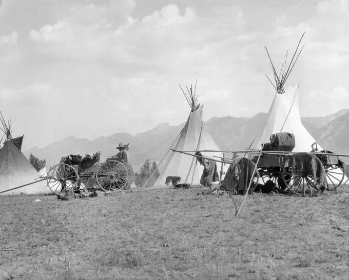 1920S 1930S Indigenous Kootenai Indigenous Camp Village Tipi Wagons Mountains In Background British Columbia, Canada