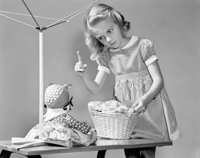 1940S Girl Shaking Her Finger At Doll Over Toy Laundry Basket