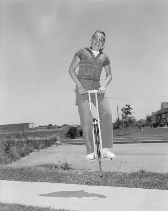 1950S Boy Jumping On Pogo Stick