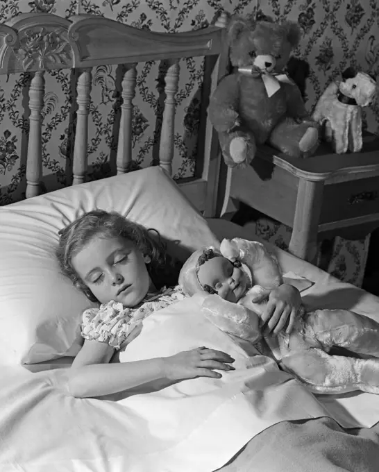 1950S 1960S Little Girl Sleeping In Bed With Arm Around A Doll