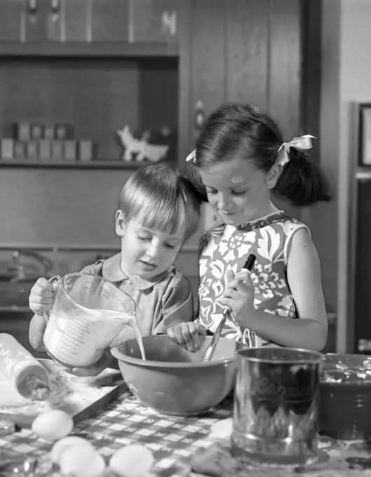 1960S Two Children Boy Girl Bowl Mixing Pouring Milk In Kitchen