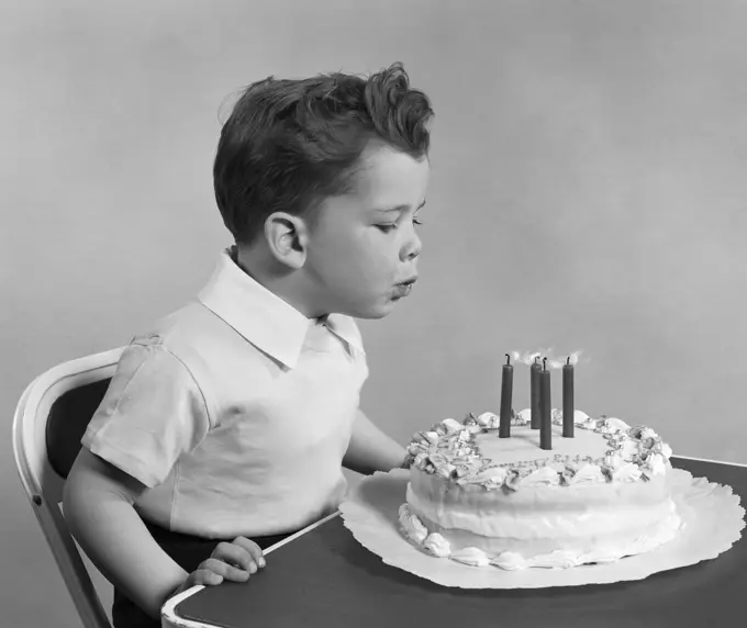 1950S Child Blowing Out Birthday Candles