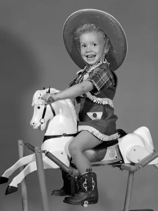 1950S Girl Dressed As Cowgirl Riding Rocking Horse