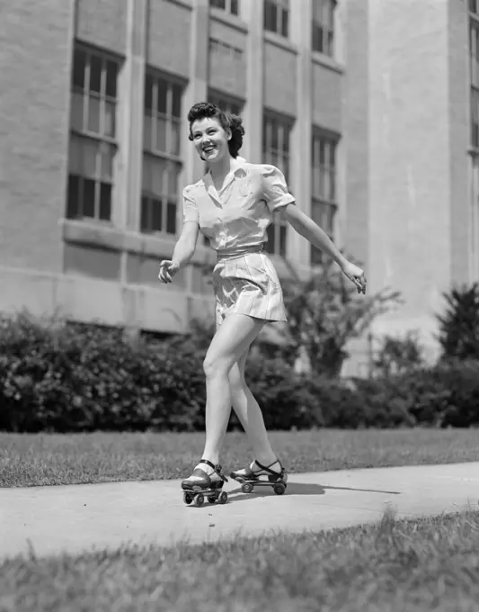 1940S Smiling Teen Girl On Roller Skates Skating On Sidewalk