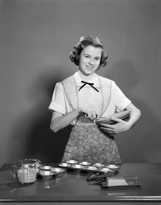 1950S Smiling Teen Girl Holding Mixing Bowl Wearing Apron Making Muffins