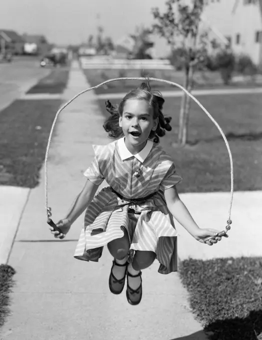 1950S Girl Jumping Rope On Sidewalk