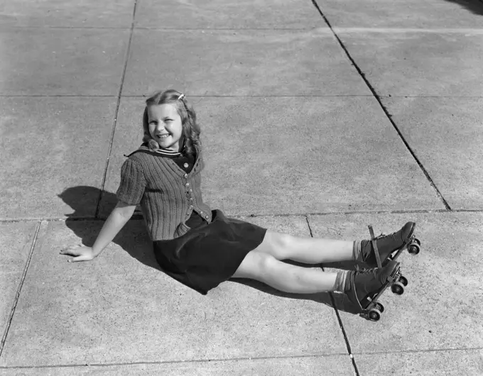 1940S Little Girl Sitting On Ground Wearing Roller-Skates