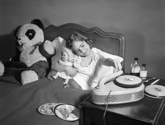 1950S Sick Child In Bed Playing With Record Player