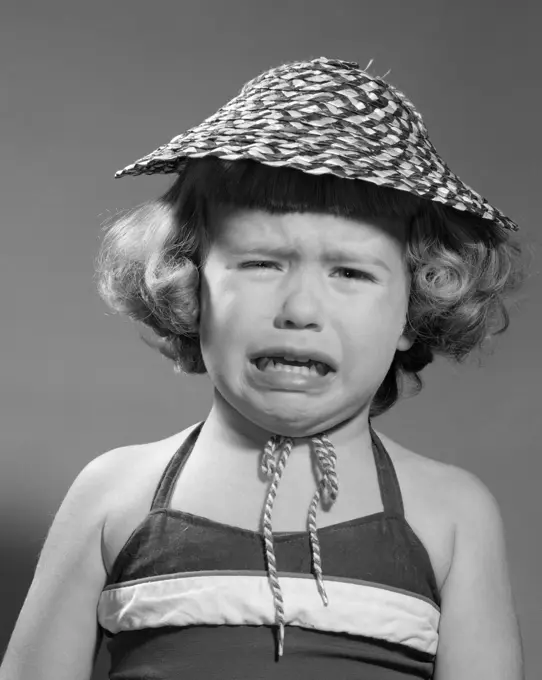 1960S Portrait Of Girl Wearing Straw Hat And Crying