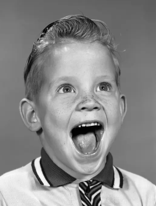 1960S Portrait Excited Boy With Mouth Wide Open Laughing