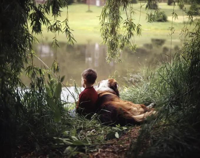 1960S 1970S Boy Fishing With His Dog By His Side