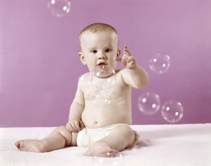 1970S Baby Trying To Catch Soap Bubbles