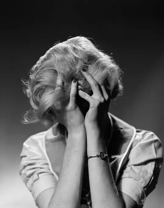 1950S Blond Woman With Headache Holding Head In Hands