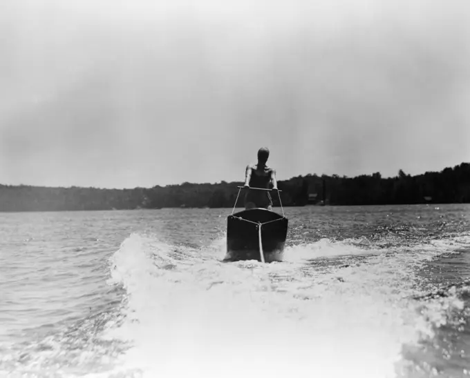 1930S Woman Aquaplaning Water Board Being Towed Behind Boat Skiing Wake Of Tow Sport Sports Nushoka Lake Canada