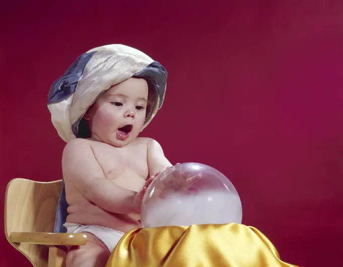 1960S Baby Fortune Teller Wearing Turban Seated With Crystal Ball