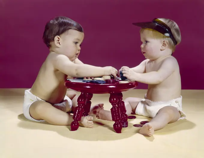 1960S Two Babies Sitting At Red Stool Playing Cards Poker With Gambling Chips