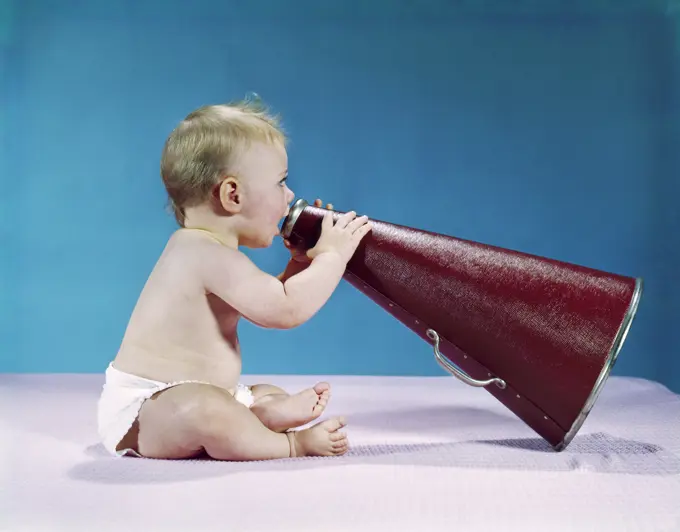 1960S Profile Of Seated Baby Shouting Yelling Speaking Into Big Megaphone