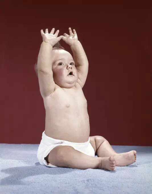 1960S Baby Wearing Cloth Diaper Sitting Arms Raised Over Head