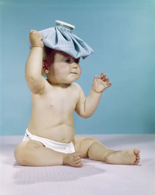 1960S Baby Sitting With Ice Pack On Top Of Head