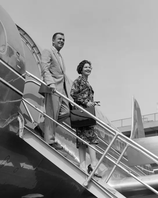 1950S Couple Exiting Plane Steps