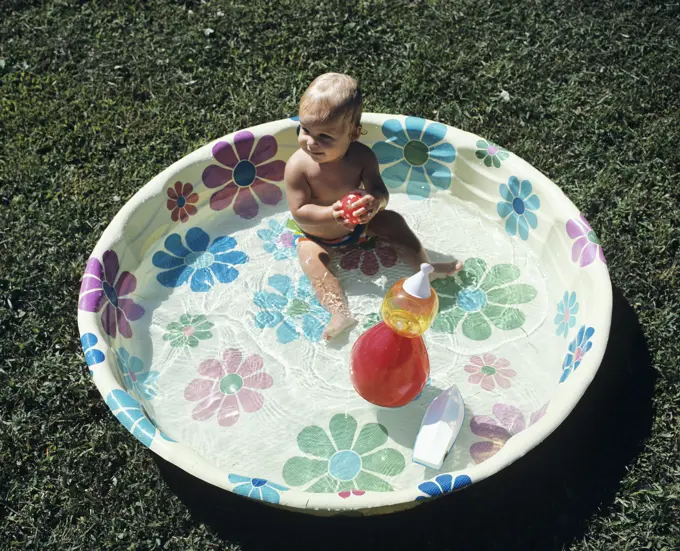 1970S Baby Sitting In Plastic Backyard Kiddy Pool Viewed From Above