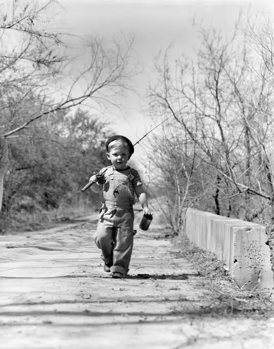 1940S Boy Walking Down Country Road With Can Of Worms And Fishing Pole