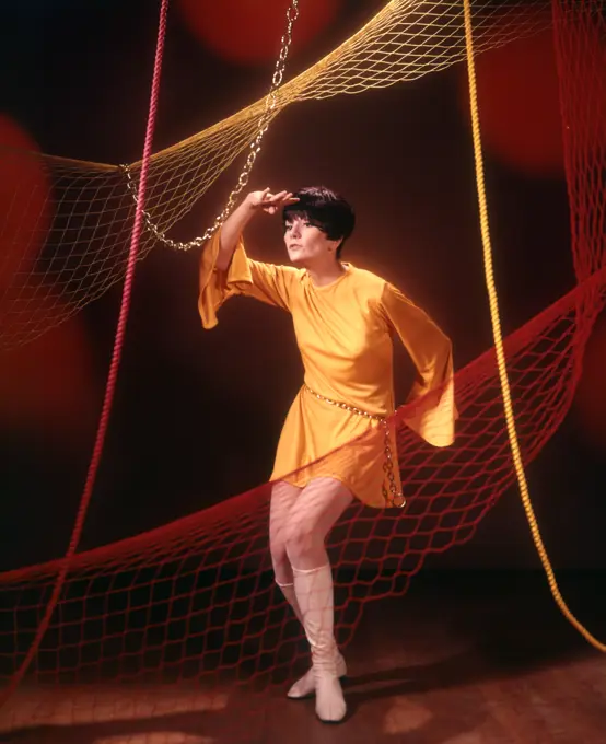 1960S 1970S Young Woman In Short Gold Tunic Dress Dancing Among Nets And Ropes