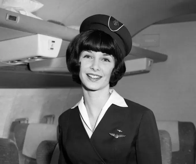 1960S Smiling Portrait Of Airline Stewardess In Airplane Aisle