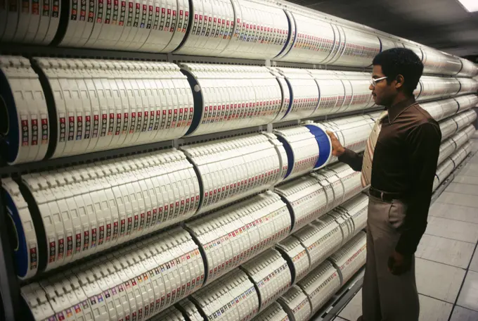 1970s 1980s AFRICAN AMERICAN MAN FILING COMPUTER 10.5-INCH DATA STORAGE TAPE REELS