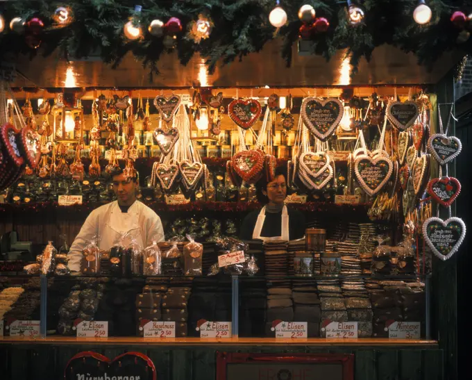 GERMANY COUPLE SELLING BAKED GOODS IN CHRISTMAS MARKET STALL