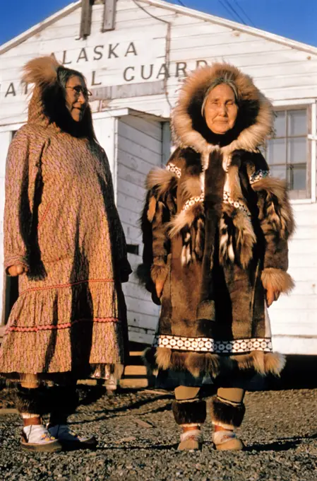 1960s TWO SENIOR NATIVE AMERICAN INDIAN INUIT WOMEN WEARING SUMMER AND WINTER FUR PARKA CLOTHING FASHIONS KOTZEBUE AK USA