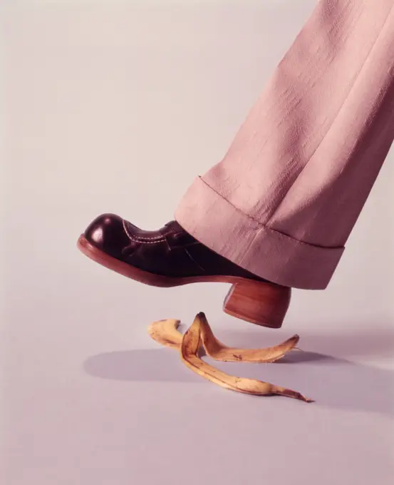 1970s MAN ABOUT TO SLIP ON BANANA PEEL ACCIDENT HAZARD DANGER SHOE SHOES STEPPING