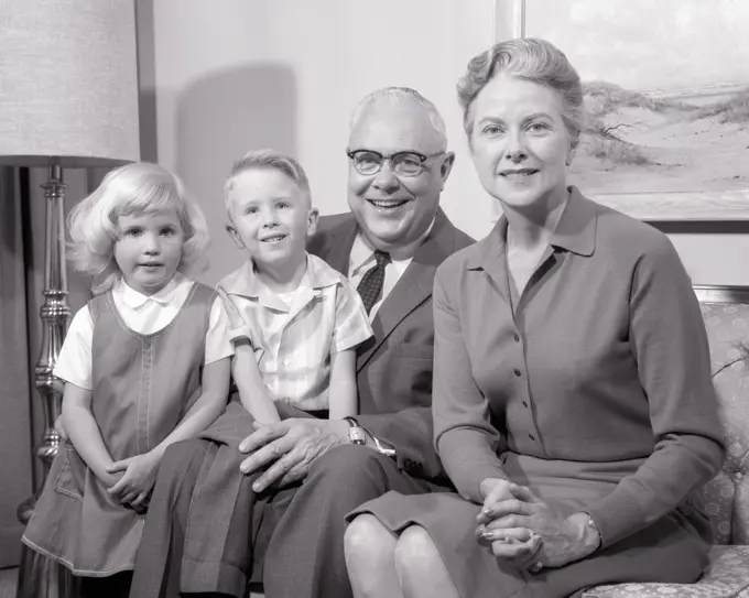 1960s PORTRAIT OF TWO GRANDPARENTS ON COUCH WITH TWO GRAND CHILDREN A BOY AND GIRL ALL LOOKING AT CAMERA - j11044 HAR001 HARS LIFESTYLE FEMALES MARRIED GRANDPARENT SPOUSE HUSBANDS HEALTHINESS HOME LIFE COPY SPACE FRIENDSHIP HALF-LENGTH LADIES PERSONS CARING MALES CONFIDENCE SENIOR MAN SENIOR ADULT B&W PARTNER EYE CONTACT SENIOR WOMAN DREAMS HAPPINESS EXCITEMENT PRIDE YOUNG AND OLD GENERATION GRANDMOTHERS RELATIONSHIPS CONNECTION GRANDDAUGHTER GRANDFATHERS GRANDSON RELATED STYLISH AGE DIFFERENCE GROWTH TOGETHERNESS WIVES BLACK AND WHITE CAUCASIAN ETHNICITY GRANDMA GRANDPA HAR001 OLD FASHIONED