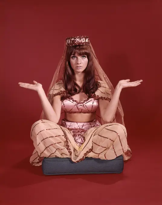 1960S Perplexed Seated Woman Dressed In Harem Dancing Girl Costume