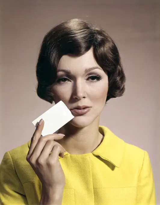 1960S Woman Holding Blank Business Card To Face