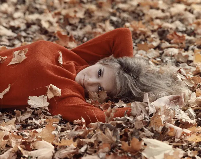 1970S Portrait Blond Woman Smiling Laying Autumn Tree Leaves