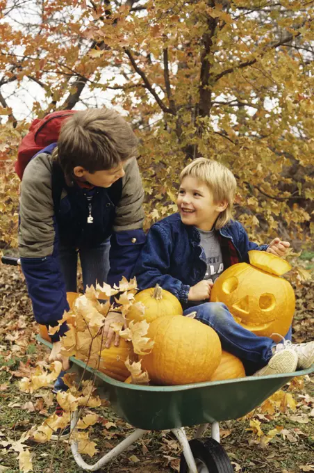 1980S Two Boys With Wheel Barrow And Halloween Pumpkins