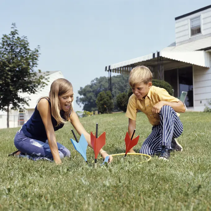 1970S Boy Girl Playing Lawn Darts Game In Backyard